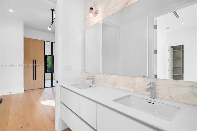 bathroom with vanity and hardwood / wood-style flooring