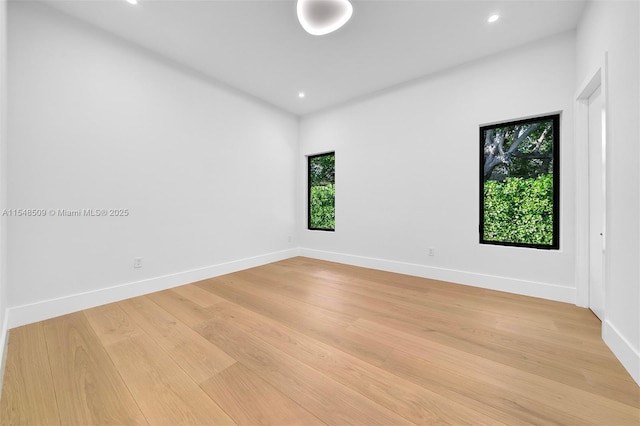 unfurnished room featuring a wealth of natural light and light hardwood / wood-style floors