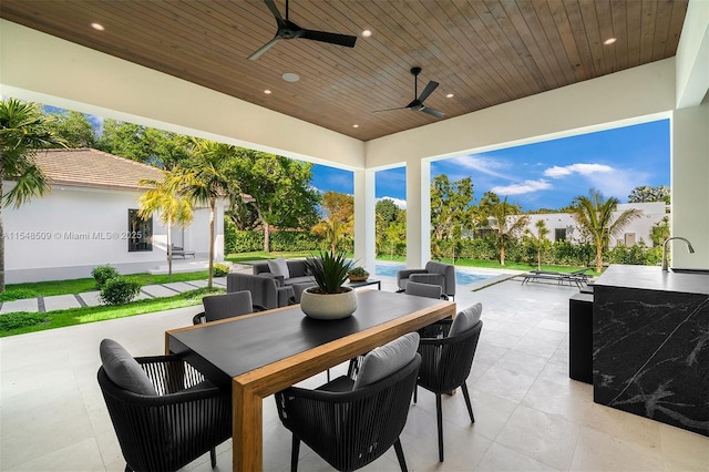 view of patio featuring ceiling fan and sink