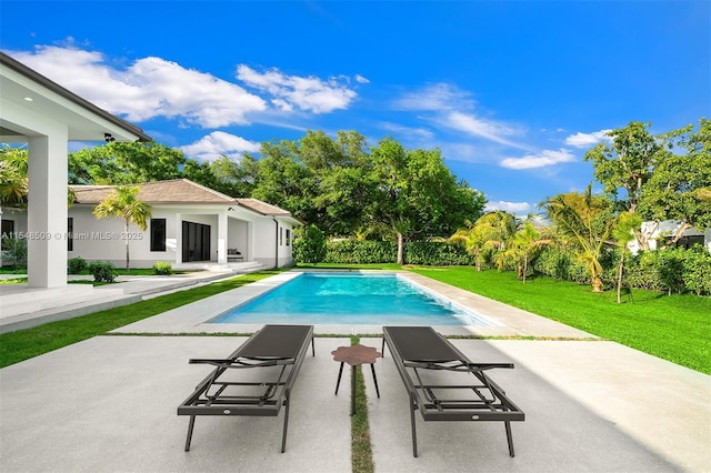 view of swimming pool with a patio area and a yard