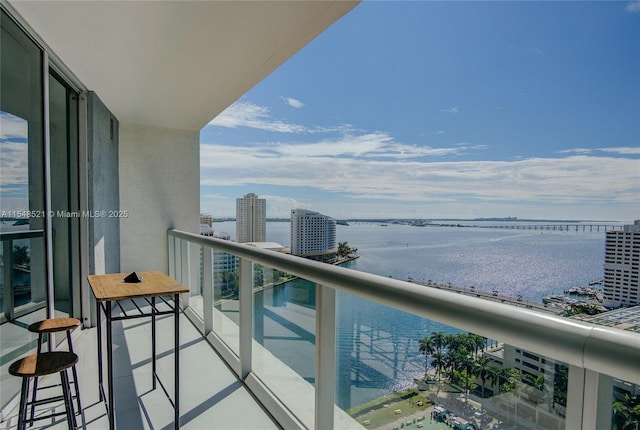 balcony featuring a view of city and a water view