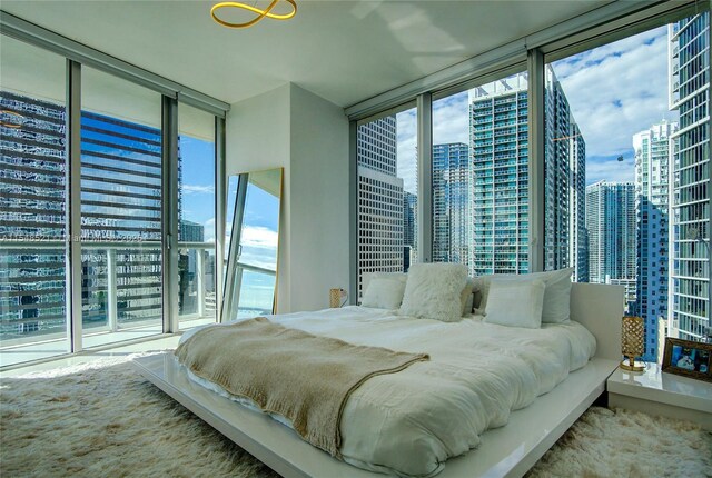 living room featuring tile floors and a wall of windows