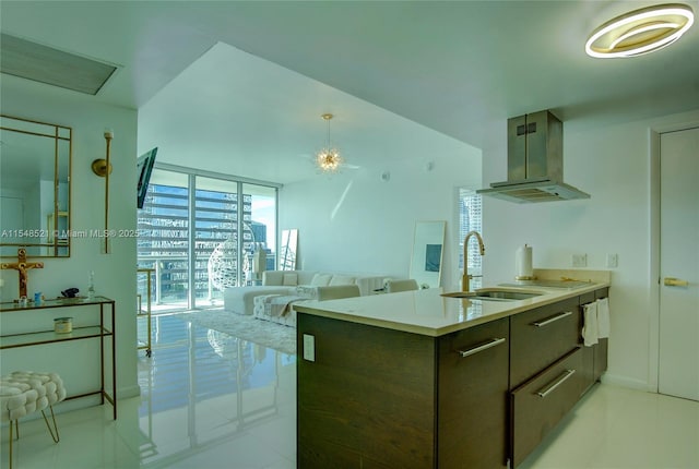 kitchen with extractor fan, a sink, open floor plan, light countertops, and modern cabinets