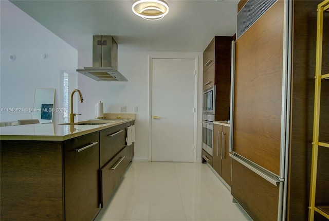 kitchen featuring stainless steel double oven, a sink, light countertops, modern cabinets, and island exhaust hood