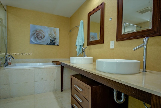 bathroom featuring double vanity, a garden tub, a sink, and tile patterned floors