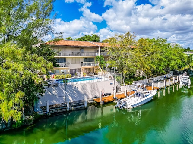 exterior space featuring a community pool and a water view