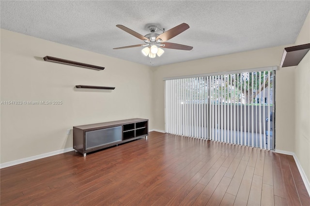 empty room featuring ceiling fan, a textured ceiling, and hardwood / wood-style flooring