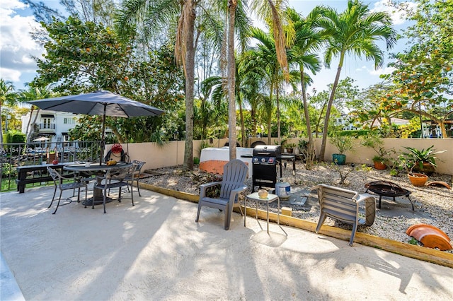 view of patio with grilling area and an outdoor fire pit