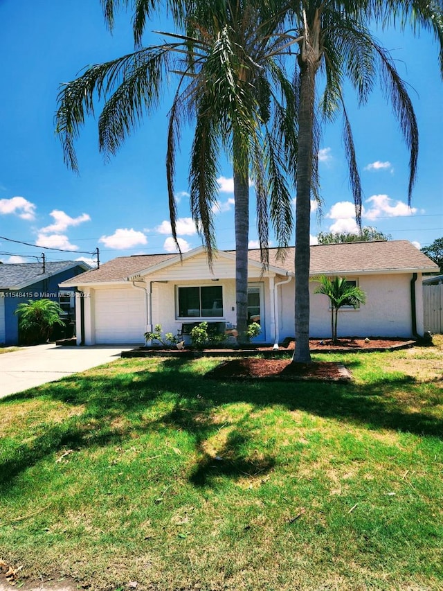 ranch-style home with a front lawn and a garage