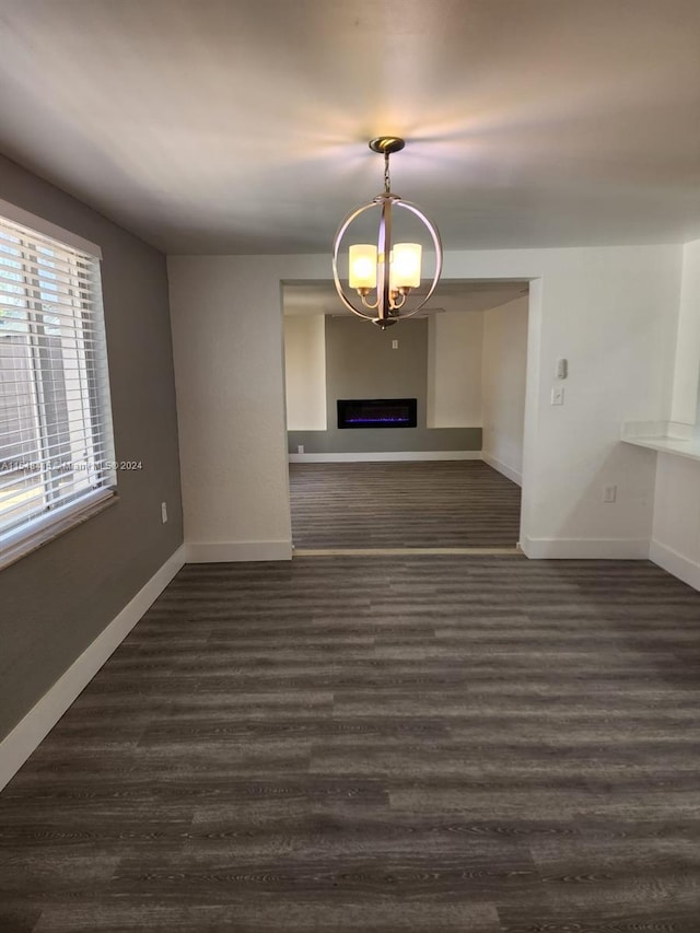 interior space featuring a chandelier and dark hardwood / wood-style floors