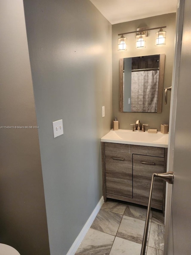 bathroom featuring tile floors and vanity with extensive cabinet space