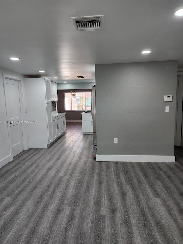 unfurnished living room featuring dark hardwood / wood-style floors