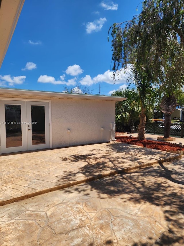 rear view of property featuring french doors and a patio