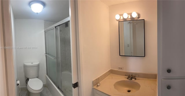 full bathroom featuring shower / bath combination with glass door, toilet, vanity, and tile flooring