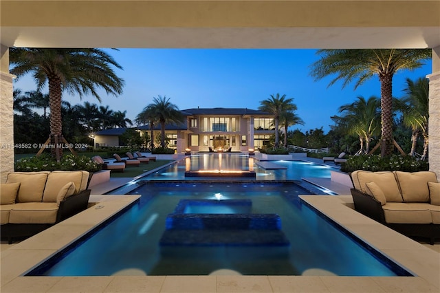 view of swimming pool featuring outdoor lounge area, a patio area, and an in ground hot tub