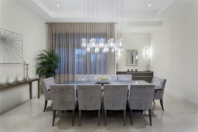 tiled dining space with a tray ceiling