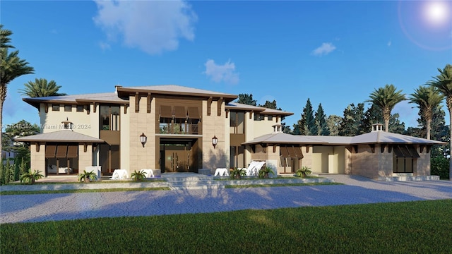 prairie-style house featuring a balcony and a front yard