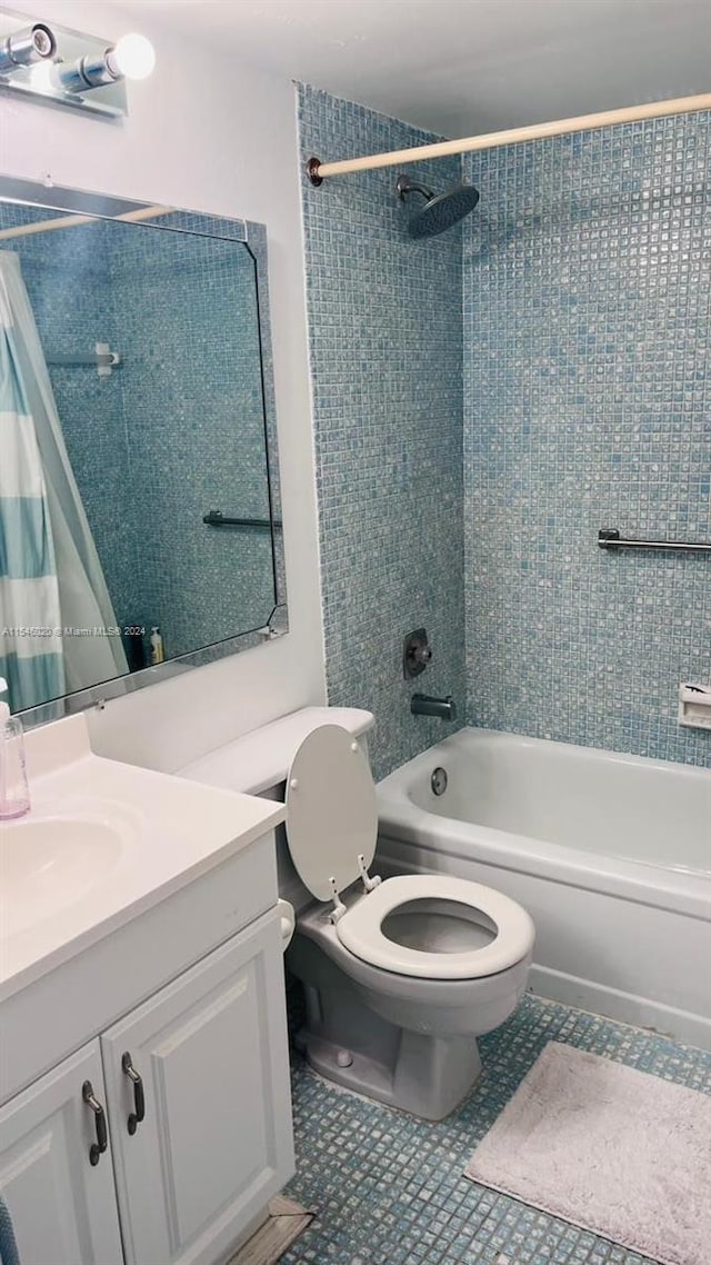 full bathroom featuring tile flooring, vanity, toilet, and shower / tub combo