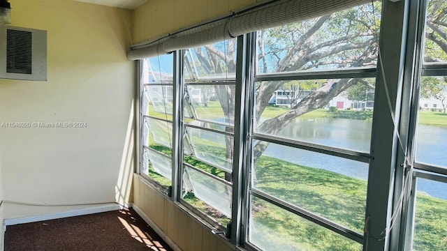 unfurnished sunroom with plenty of natural light and a water view