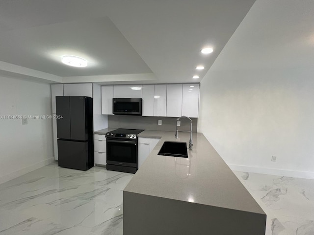 kitchen featuring black appliances, sink, and white cabinets