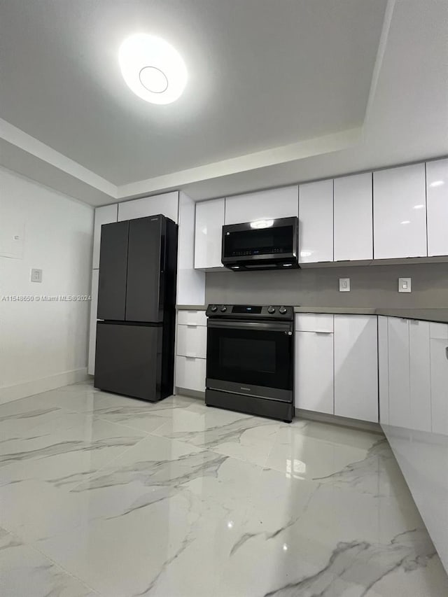 kitchen with black appliances and white cabinetry