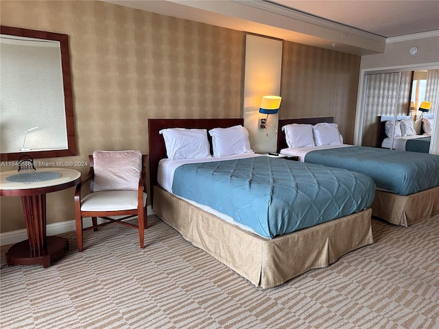 carpeted bedroom featuring crown molding