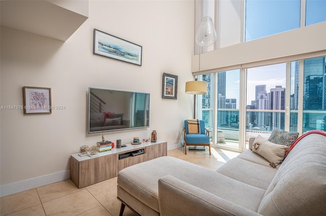 living room with light tile patterned flooring and a high ceiling