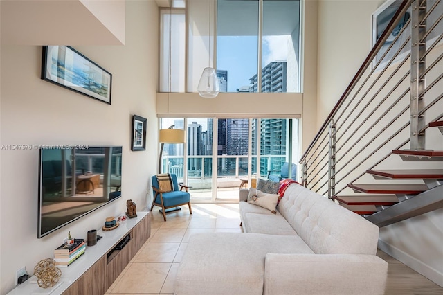 tiled living room featuring a high ceiling