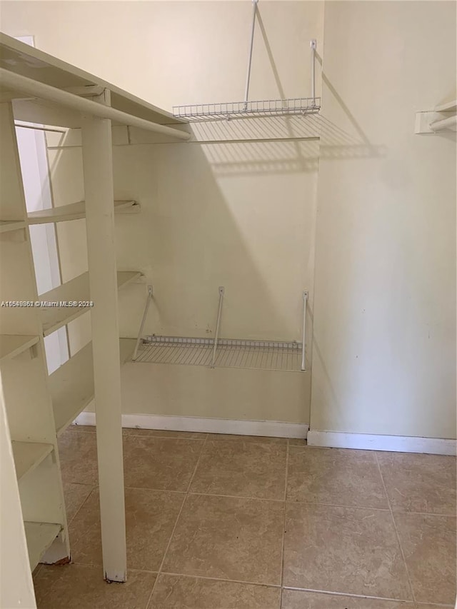 spacious closet featuring tile floors