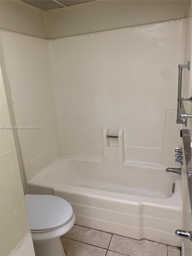 bathroom featuring  shower combination, tile flooring, and toilet