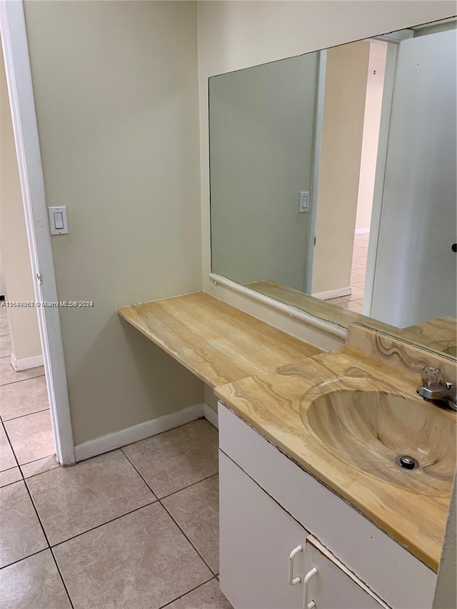 bathroom featuring vanity and tile flooring