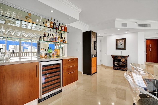 bar with light tile patterned flooring, wine cooler, and ornamental molding