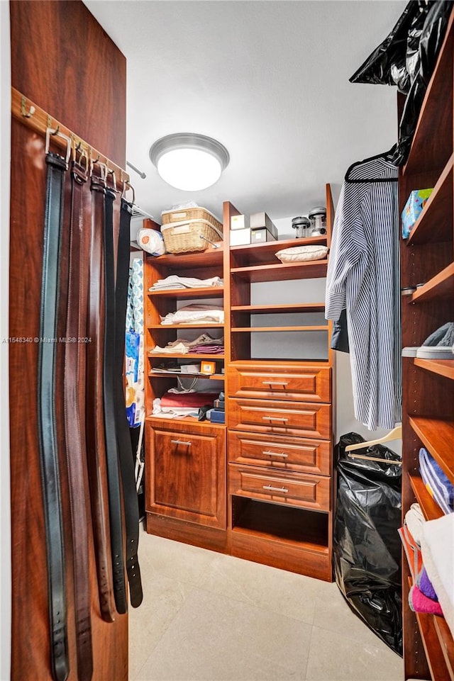 walk in closet with tile patterned floors