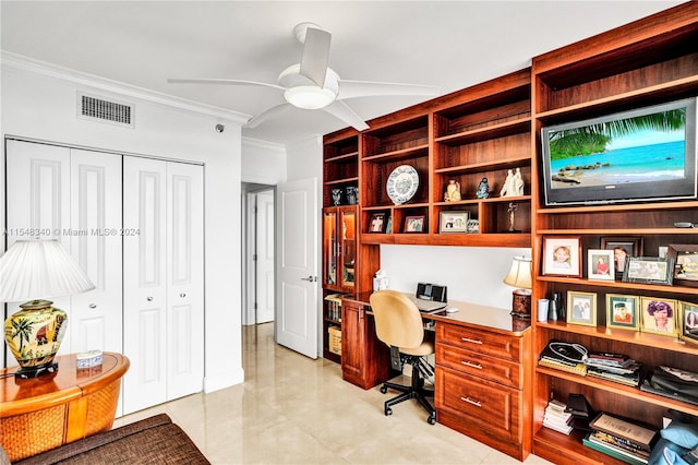 tiled office space with crown molding, ceiling fan, and built in desk