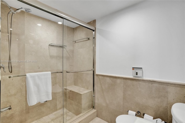 bathroom featuring walk in shower, tile walls, and toilet