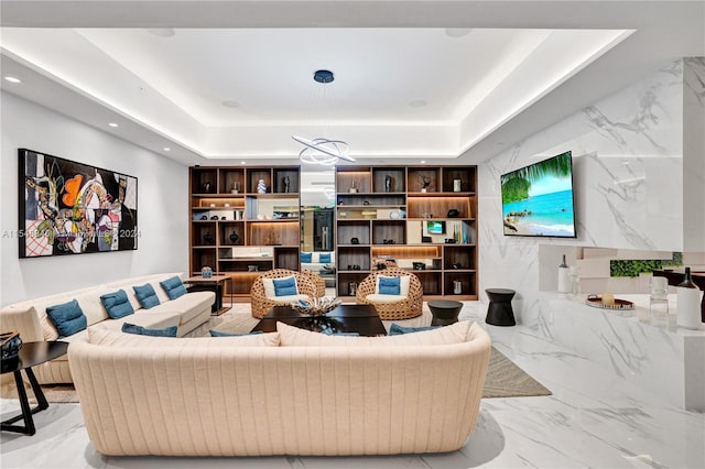 tiled living room featuring a tray ceiling