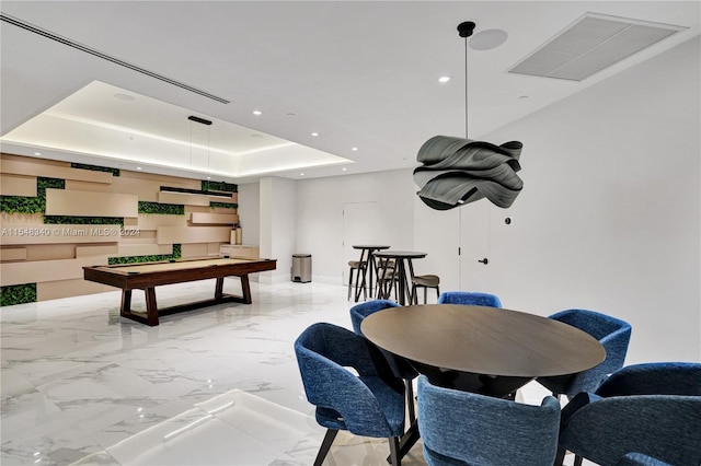 game room with pool table, light tile patterned floors, and a tray ceiling