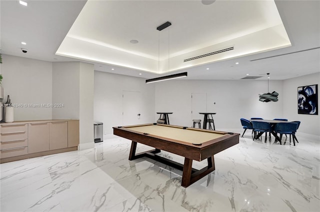 playroom with pool table, light tile patterned floors, and a raised ceiling