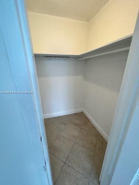 spacious closet featuring tile flooring