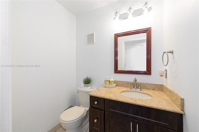 bathroom featuring toilet and vanity