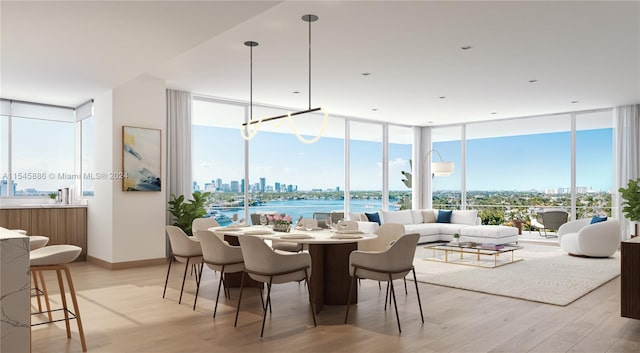 dining space featuring a wall of windows, a water view, and light hardwood / wood-style floors