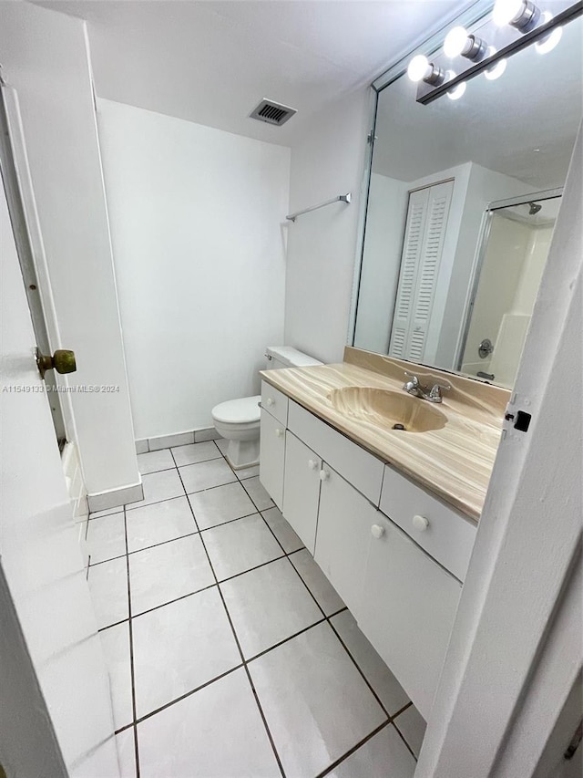 bathroom featuring toilet, large vanity, and tile floors