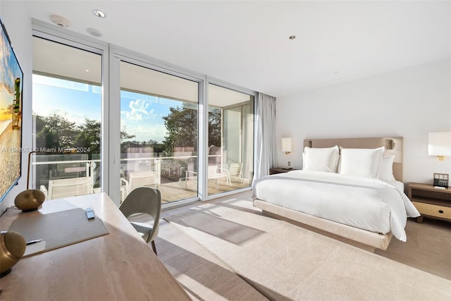 bedroom featuring a wall of windows and access to exterior