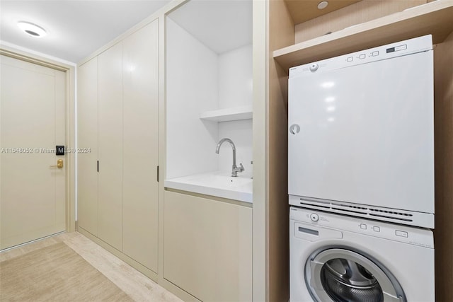 laundry room featuring stacked washer and dryer