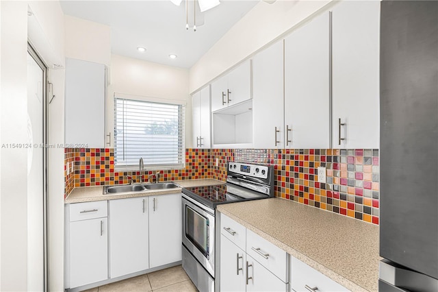 kitchen with ceiling fan, sink, white cabinets, backsplash, and stainless steel appliances