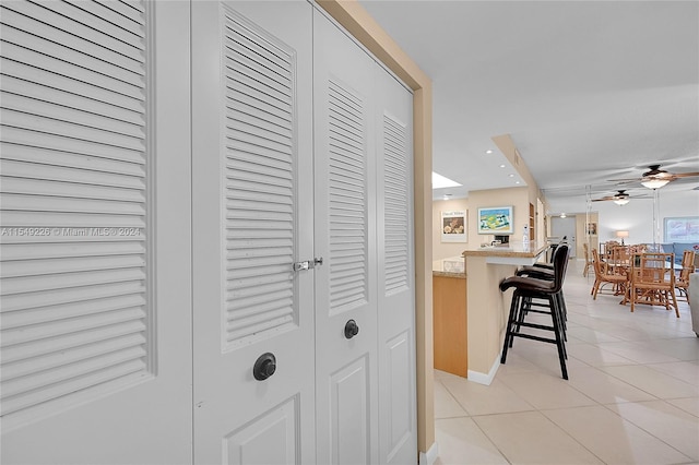 hall featuring light tile floors