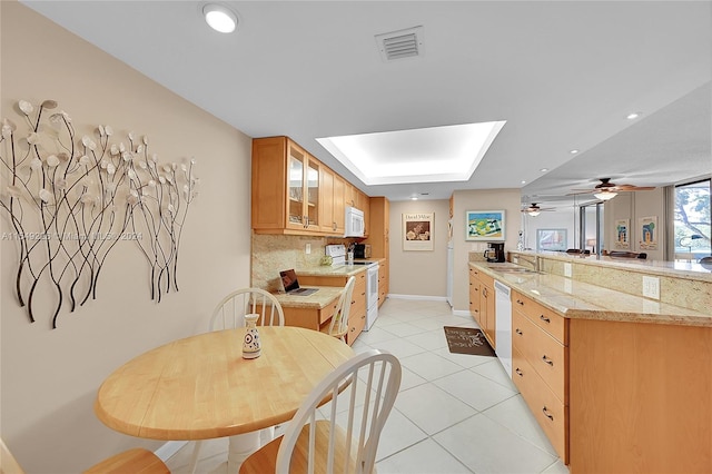 kitchen with light tile floors, ceiling fan, white appliances, backsplash, and sink