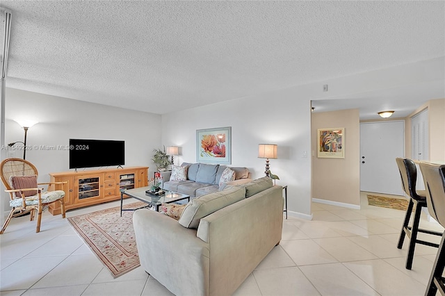 living room with light tile flooring and a textured ceiling