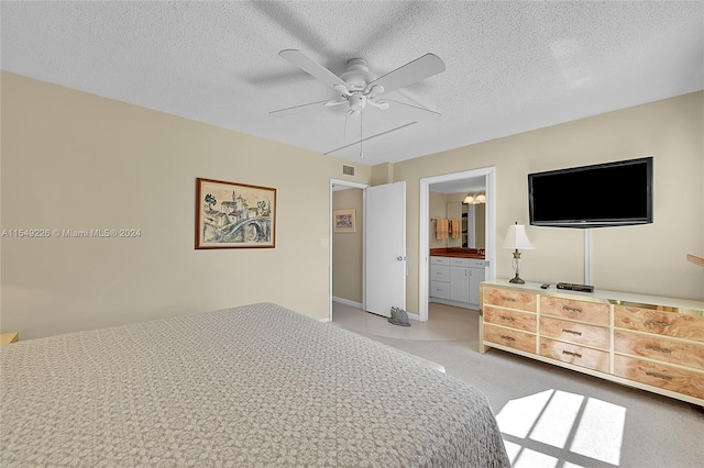 tiled bedroom featuring a textured ceiling, ceiling fan, and ensuite bathroom