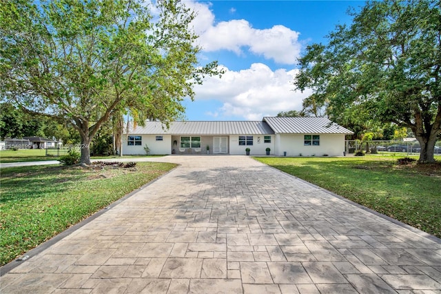 ranch-style house with a front lawn